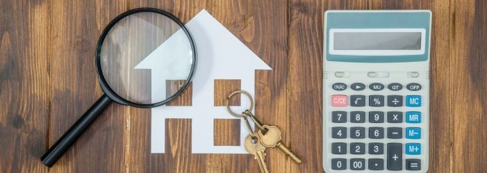 A magnifying glass, keys, and a calculator are on a wooden table emphasizing the Mortgage Basics and Options