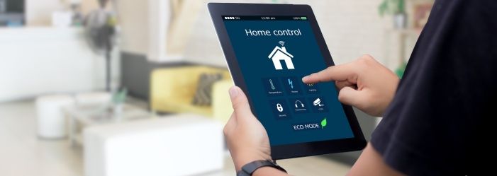 A person is holding a tablet in his hand managing his home emphasizing the Home equity and Smart Mortgage Decisions